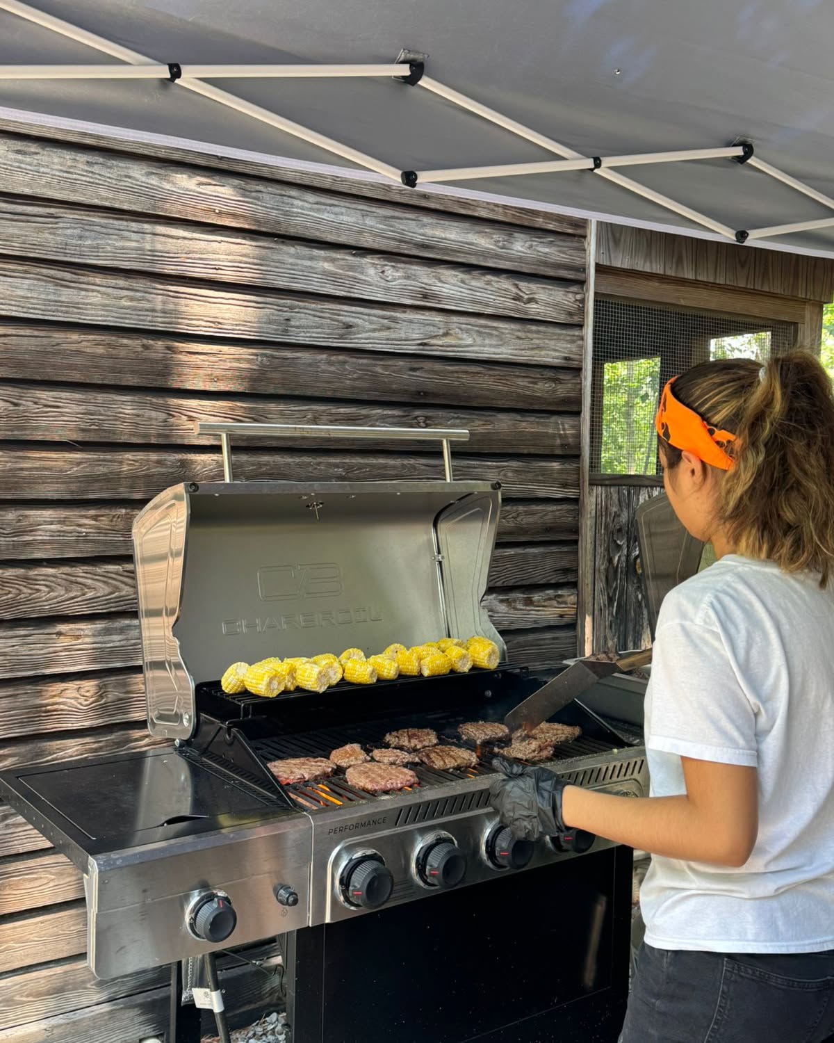 Grilling corn and burgers outdoors