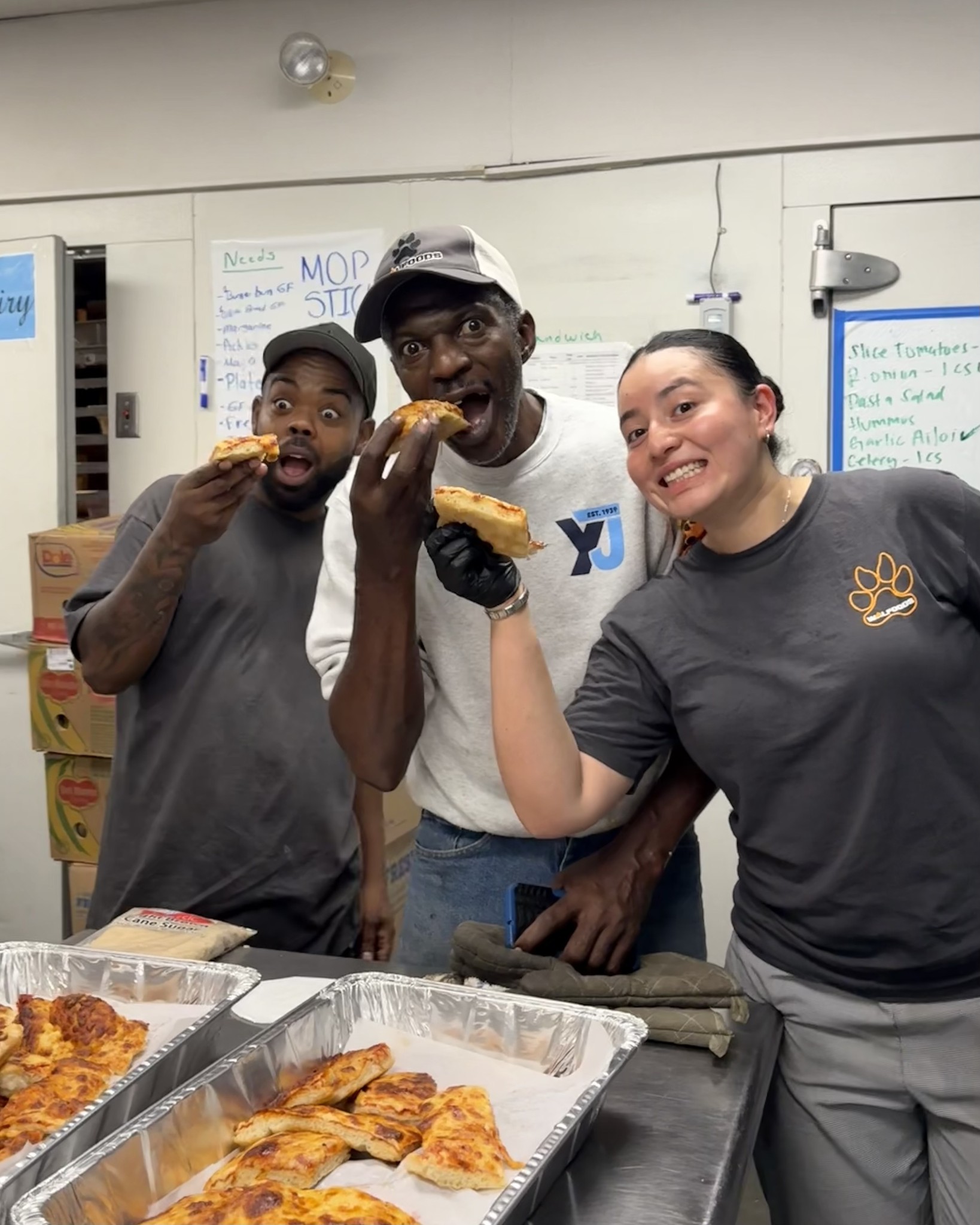 Team enjoying pizza in the kitchen
